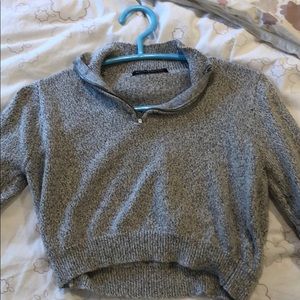 Brandy. Grey cropped sweater.